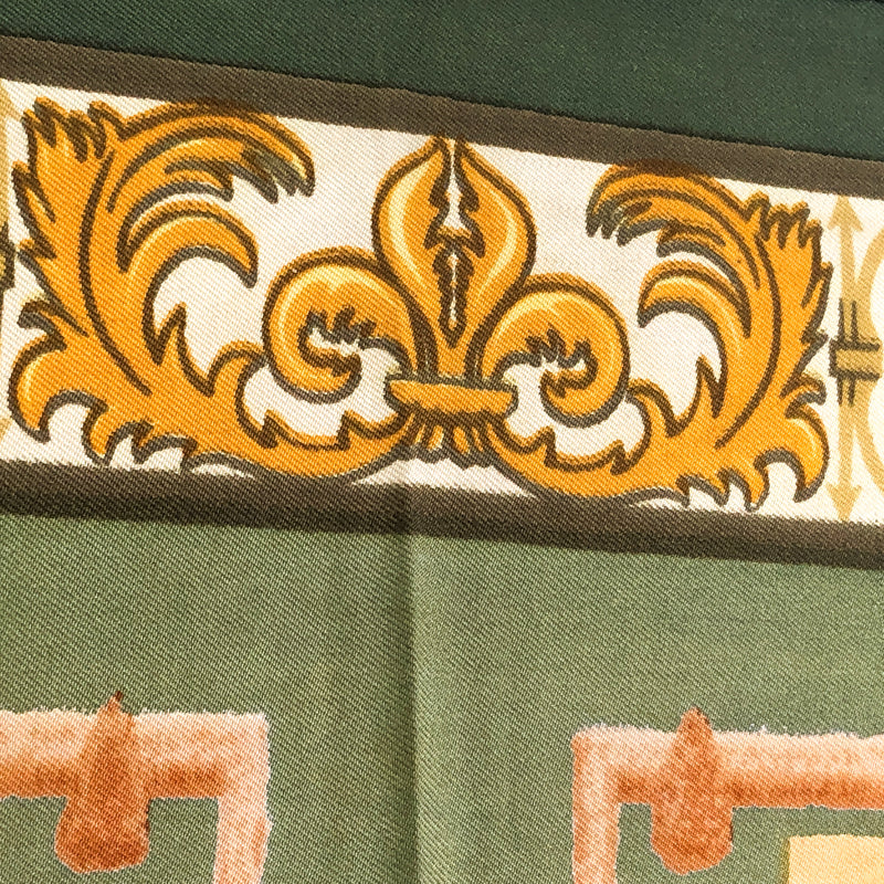 close up of fleurs de lis on upper part of scarf