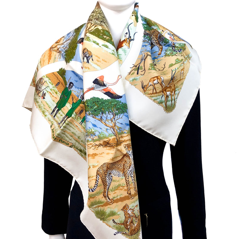 Tanzanie Hermes scarf in brown and green tones against a cream background