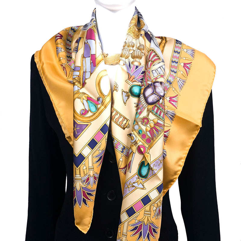 Tresors du Nil Hermes Scarf in Yellows over a black jacket
